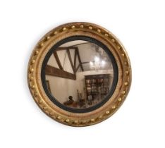 A REGENCY GILTWOOD CIRCULAR CONVEX MIRROR,CIRCA 1815