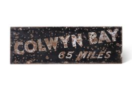 AN ENAMEL ROAD SIGN 'COLWYN BAY 65 MILES' PROBABLY, FIRST HALF 20TH CENTURY