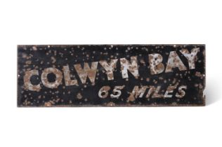 AN ENAMEL ROAD SIGN 'COLWYN BAY 65 MILES' PROBABLY, FIRST HALF 20TH CENTURY