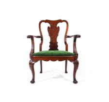 A CARVED MAHOGANY AND 'PLUM PUDDING' MAHOGANY OPEN ARMCHAIR, IN GEORGE II STYLE