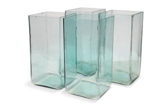 A SET OF FOUR LARGE GLASS BATTERY ACID JARS, CIRCA 1900