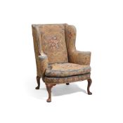 A WALNUT AND NEEDLEWORK UPHOLSTERED WING ARMCHAIR, IN GEORGE II STYLE, 19TH OR EARLY 20TH CENTURY