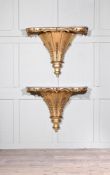 A PAIR OF CARVED GILTWOOD CONSOLES OR LARGE WALL BRACKETS, IN THE MANNER OF GILLOWS