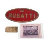 A CAST BRASS OR BRONZE AND PAINTED SIGN FOR 'BUGATTI'