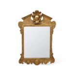 A GEORGE II CARVED GILTWOOD MIRROR, CIRCA 1730