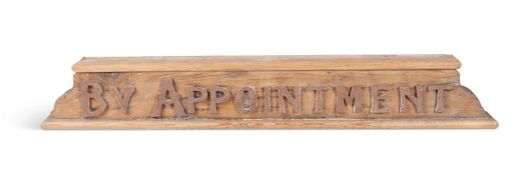 A CARVED PINE AND HARDWOOD SIGN 'BY APPOINTMENT', 20TH CENTURY