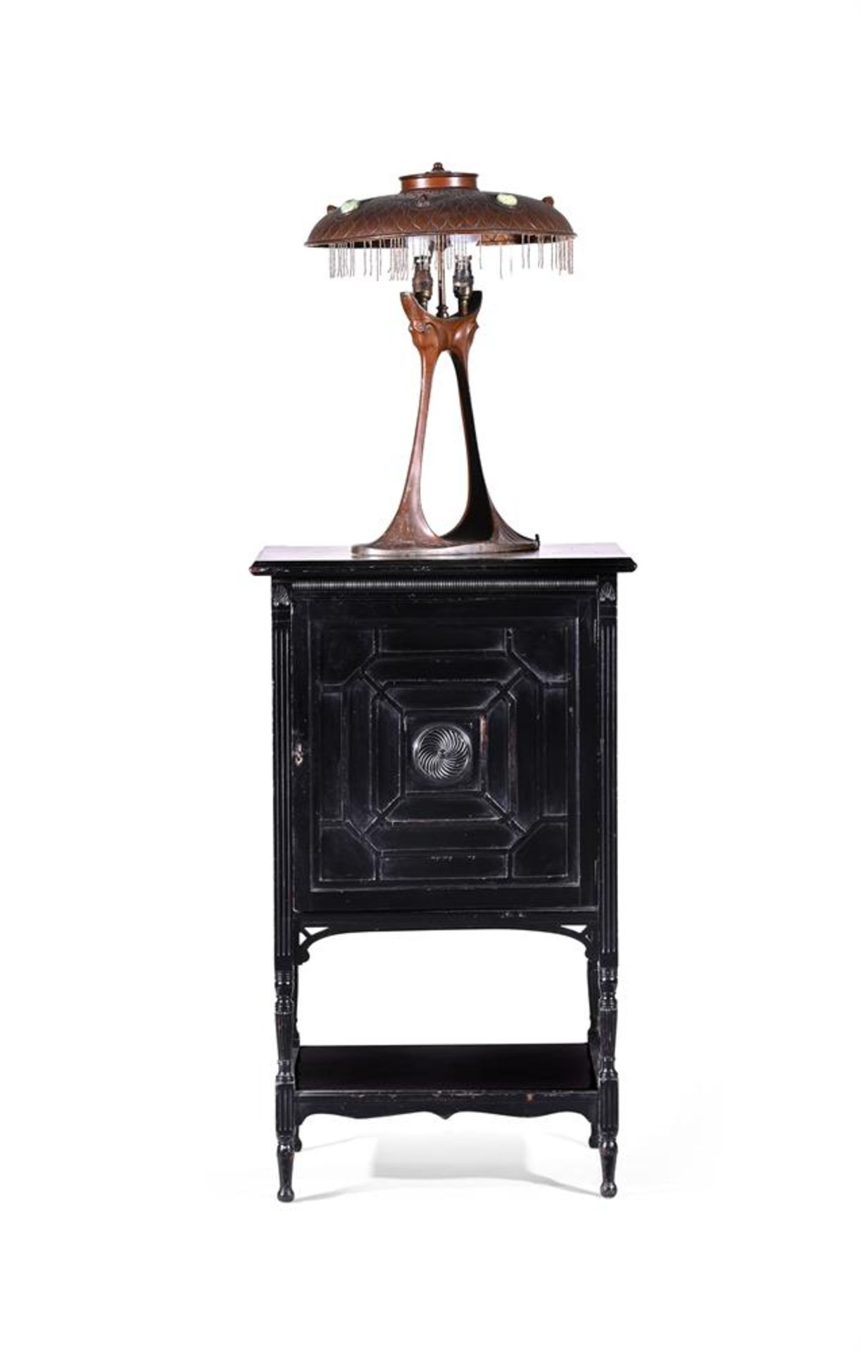 AN AESTHETIC MOVEMENT CARVED AND EBONISED CABINET, AFTER DESIGNS BY ERNEST GIMSON