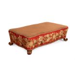 A WILLIAM IV CARVED WALNUT AND NEEDLEWORK UPHOLSTERED SERPENTINE FOOTSTOOL OR OTTOMAN, CIRCA 1835