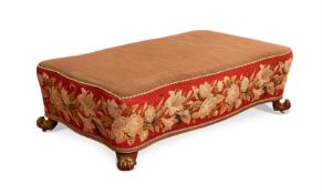 A WILLIAM IV CARVED WALNUT AND NEEDLEWORK UPHOLSTERED SERPENTINE FOOTSTOOL OR OTTOMAN, CIRCA 1835
