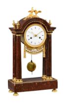 A FRENCH EMPIRE ORMOLU MOUNTED ROSSO FRANCIA MARBLE PORTICO MANTEL CLOCK