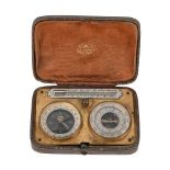 AN EDWARDIAN CASED ANEROID BAROMETER, COMPASS AND THERMOMETER COMPENDIUM