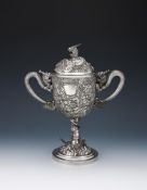 A CHINESE SILVER TWIN HANDLED CUP AND COVER