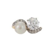 A DIAMOND AND PEARL CROSSOVER RING, FIRST HALF OF THE 20TH CENTURY