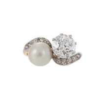 A DIAMOND AND PEARL CROSSOVER RING, FIRST HALF OF THE 20TH CENTURY