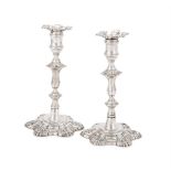 A PAIR OF GEORGE II CAST SILVER CANDLESTICKS