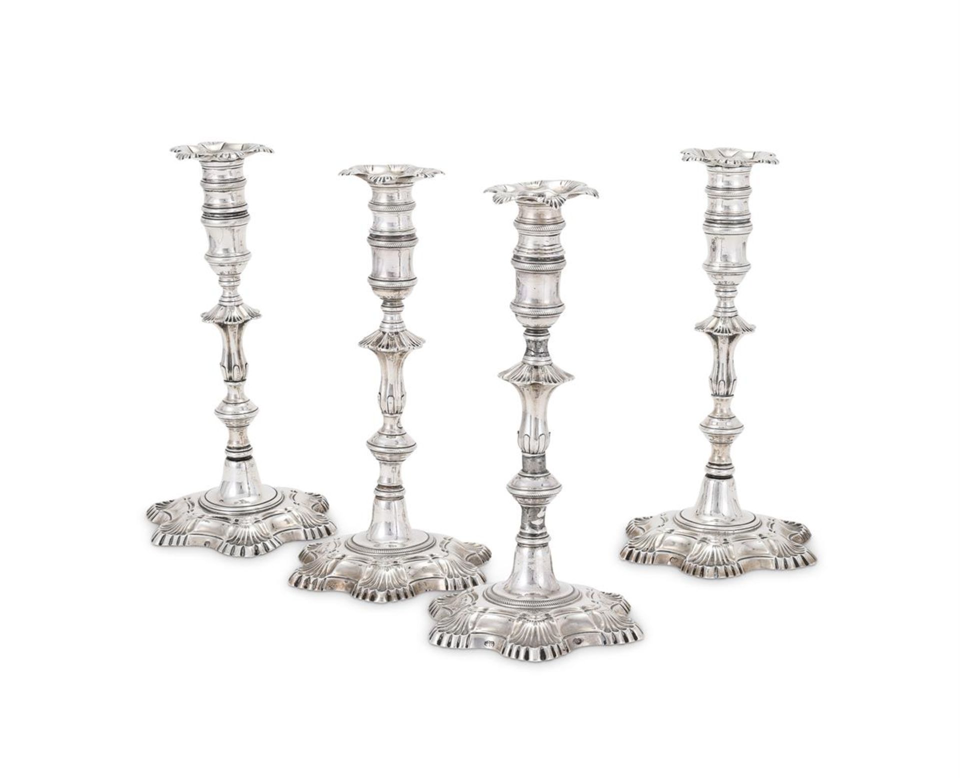 A SET OF FOUR GEORGE III IRISH SILVER CANDLESTICKS