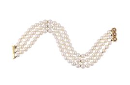 A FRENCH THREE STRAND CULTURED PEARL BRACELET WITH A DIAMOND CLASP