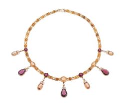 A LATE 19TH CENTURY GARNET, TOPAZ AND WHITE ENAMEL FRINGE NECKLACE, ATTRIBUTED TO ALFRED PHILLIPS
