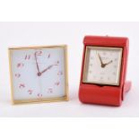 TIFFANY & CO., A GILT METAL AND RED LEATHER TRAVEL ALARM 8 DAY DESK CLOCK