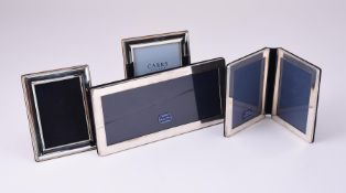 FOUR SILVER MOUNTED PHOTO FRAMES