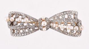 AN EARLY 20TH CENTURY SEED PEARL AND DIAMOND BOW BROOCH