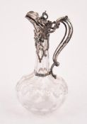 A VICTORIAN SILVER MOUNTED CUT GLASS CLARET JUG