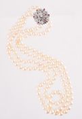 A TWO ROW CULTURED PEARL NECKLACE WITH A DIAMOND AND RUBY FLOWER HEAD CLUSTER CLASP