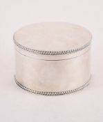 A SILVER CIRCULAR BISCUIT TIN