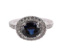 A SAPPHIRE AND DIAMOND CLUSTER RING