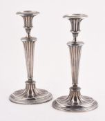 A PAIR OF SILVER CANDLESTICKS