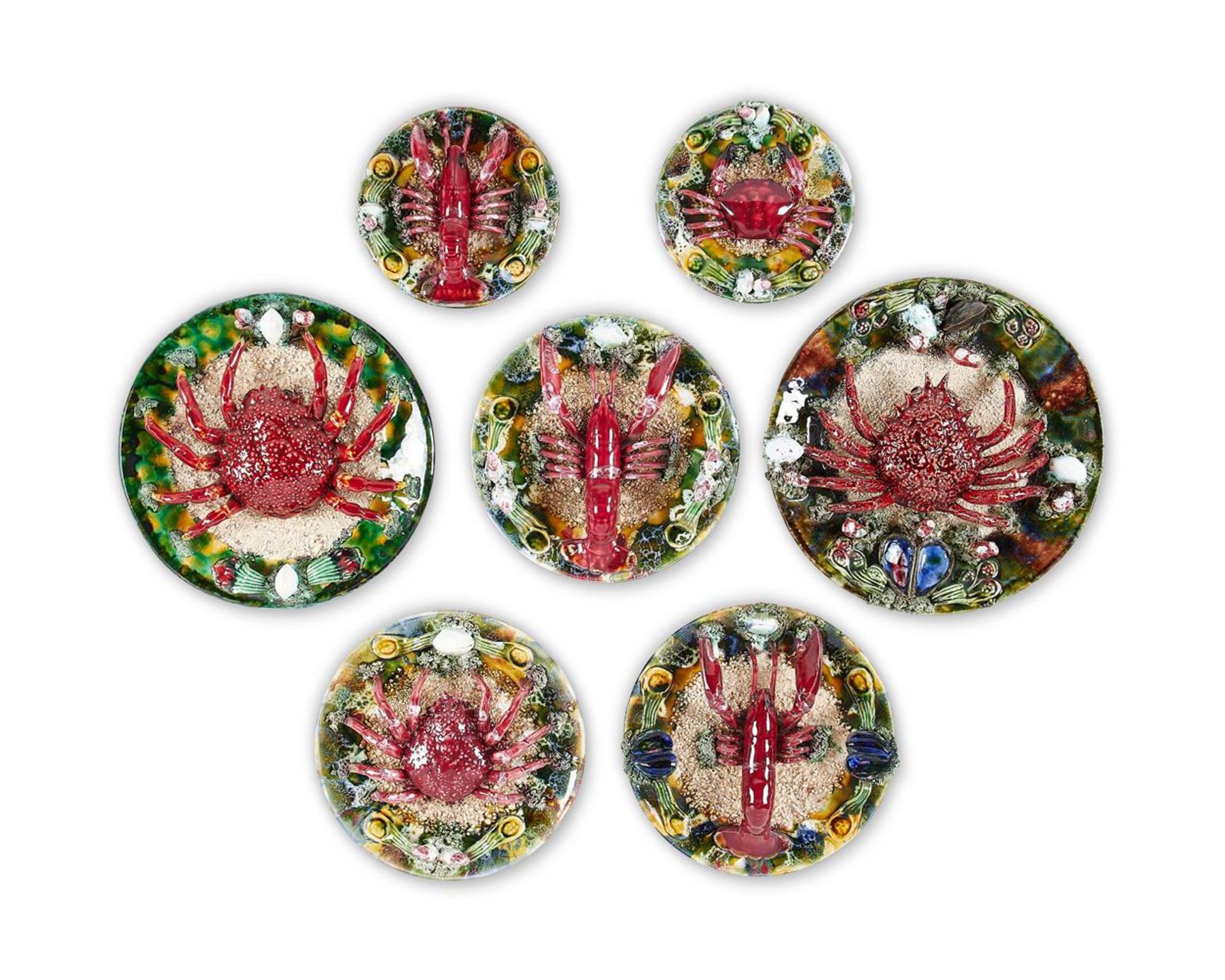 A GROUP OF SEVEN SIMILAR CALDAS DA RAINHA MAIOLICA PLATES IN BERNARD PALISSY STYLE, PORTUGAL