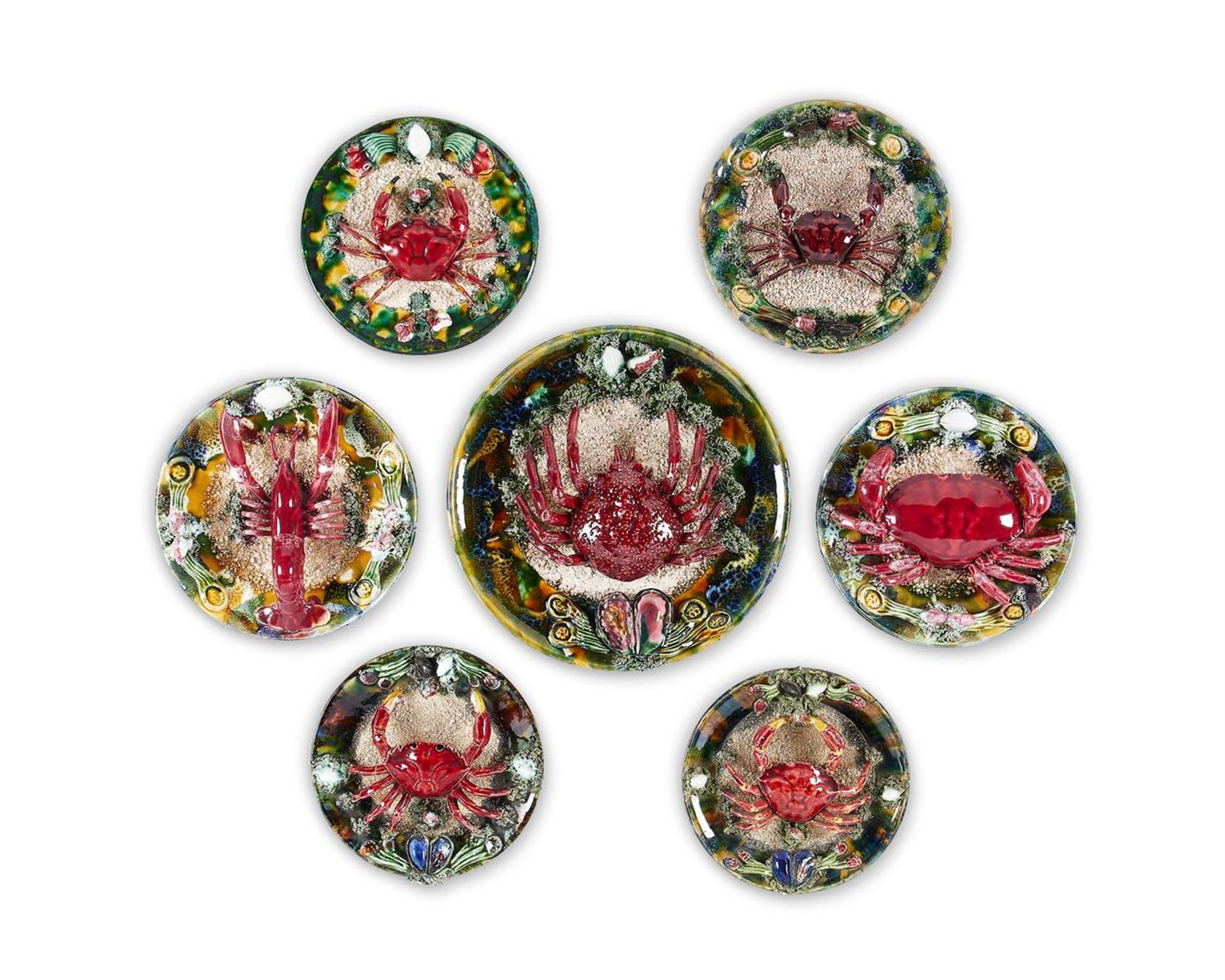 A GROUP OF SEVEN SIMILAR CALDAS DA RAINHA MAIOLICA PLATES IN BERNARD PALISSY STYLE, PORTUGAL