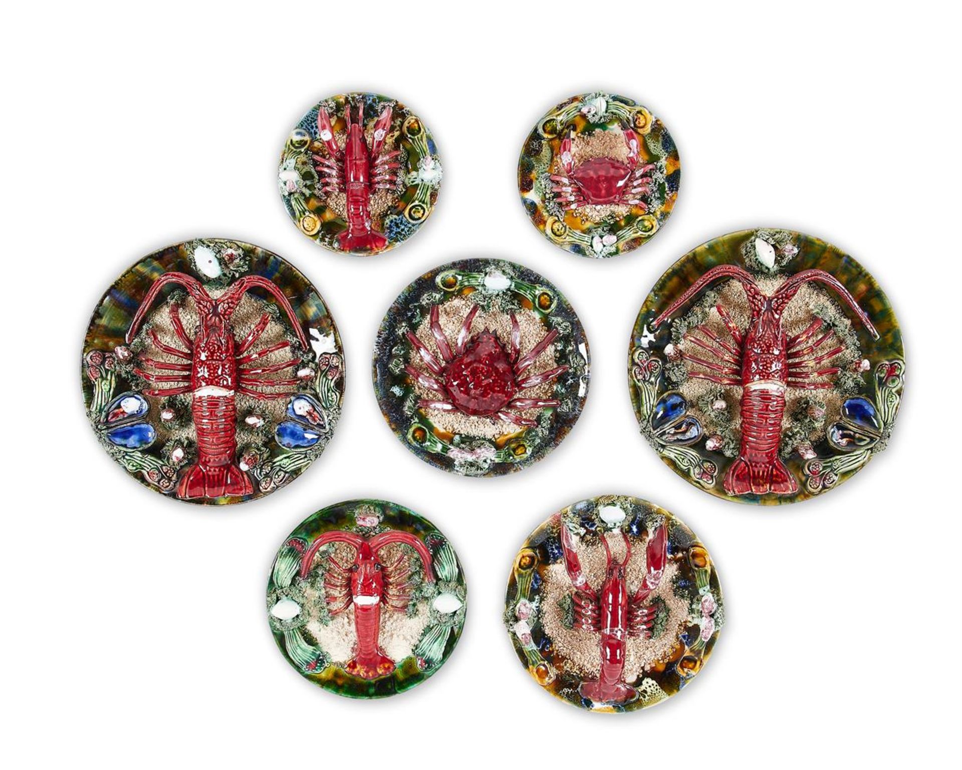 A GROUP OF SEVEN SIMILAR CALDAS DA RAINHA MAIOLICA PLATES IN BERNARD PALISSY STYLE, PORTUGAL