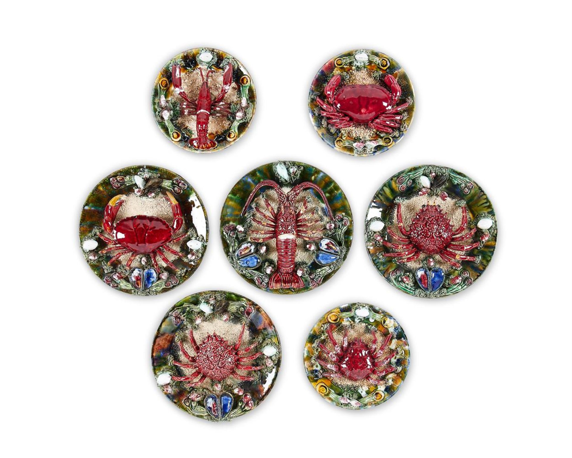 A GROUP OF SEVEN SIMILAR CALDAS DA RAINHA MAIOLICA PLATES IN BERNARD PALISSY STYLE, PORTUGAL