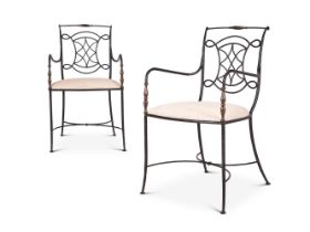 A PAIR OF FRENCH BRASS MOUNTED IRON OPEN ARM CHAIRS IN THE MANNER OF GILBERT POILLERAT (B.1902-1988)