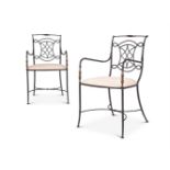 A PAIR OF FRENCH BRASS MOUNTED IRON OPEN ARM CHAIRS IN THE MANNER OF GILBERT POILLERAT (B.1902-1988)