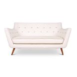 A CREAM LEATHERETTE UPHOLSTERED SOFA, MODERN, IN THE STYLE OF FINN JUHL