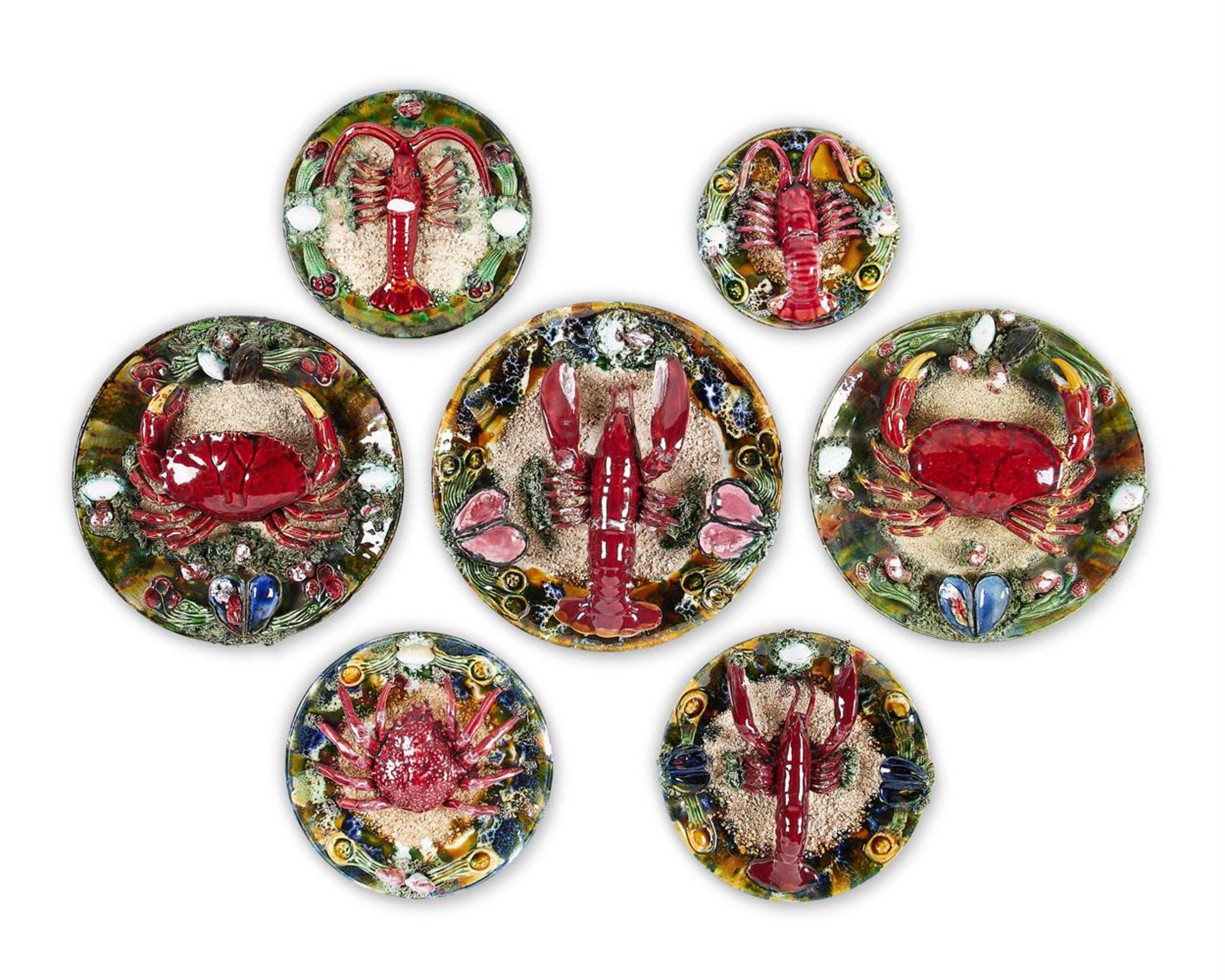 A GROUP OF SEVEN SIMILAR CALDAS DA RAINHA MAIOLICA PLATES IN BERNARD PALISSY STYLE, PORTUGAL