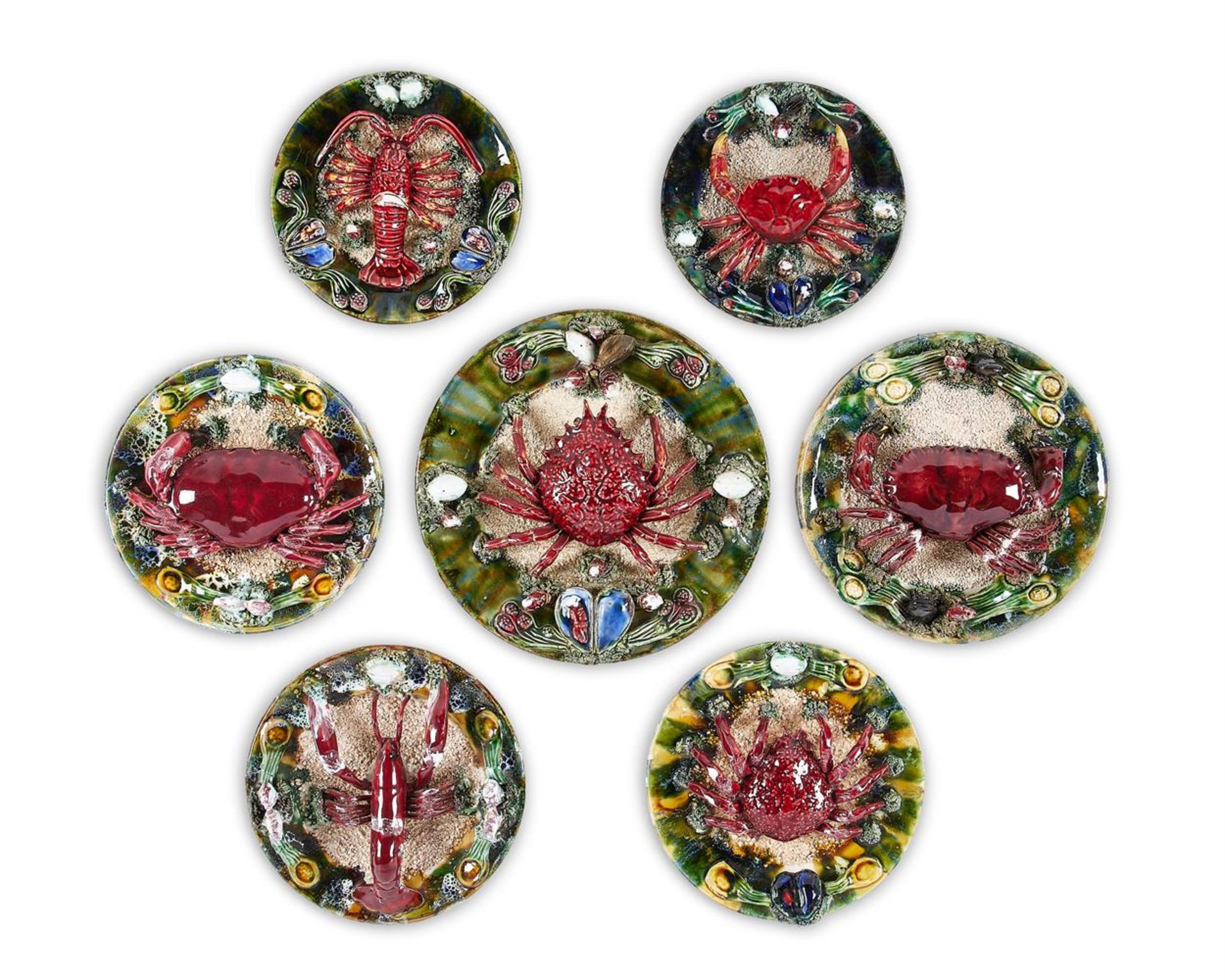 A GROUP OF SEVEN SIMILAR CALDAS DA RAINHA MAIOLICA PLATES IN BERNARD PALISSY STYLE, PORTUGAL