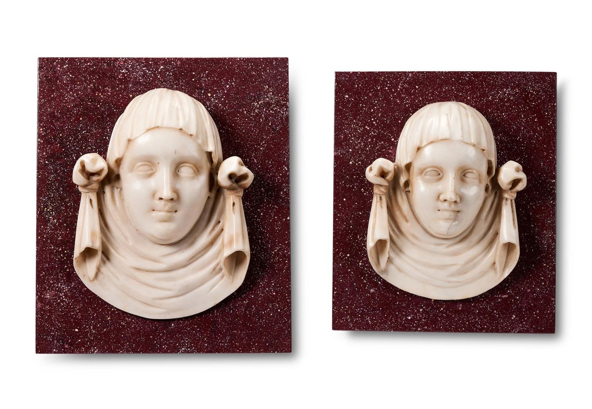 A PAIR OF ITALIAN STATUARY MARBLE FEMALE MASK PANELS, 17TH/18TH CENTURY