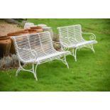 A PAIR OF HAND FORGED AND WHITE PAINTED 'ARRAS' GARDEN BENCHES, OF RECENT MANUFACTURE