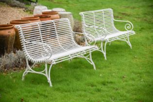 A PAIR OF HAND FORGED AND WHITE PAINTED 'ARRAS' GARDEN BENCHES, OF RECENT MANUFACTURE