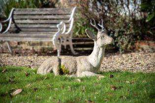 A COMPOSITION STONE MODEL OF A RECUMBENT STAG, OF RECENT MANUFACTURE