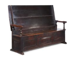 A CARVED OAK METAMORPHIC TABLE SETTLE, LATE 17TH OR EARLY 18TH CENTURY