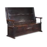 A CARVED OAK METAMORPHIC TABLE SETTLE, LATE 17TH OR EARLY 18TH CENTURY