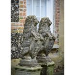 A PAIR OF COMPOSITION STONE HERALDIC LIONS, 20TH CENTURY