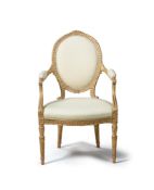 A GEORGE III CARVED GILTWOOD AND UPHOLSTERED OPEN ARMCHAIR, IN THE MANNER OF THOMAS CHIPPENDALE