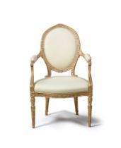 A GEORGE III CARVED GILTWOOD AND UPHOLSTERED OPEN ARMCHAIR, IN THE MANNER OF THOMAS CHIPPENDALE