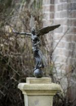 AFTER THE ANTIQUE, A BRONZE FIGURE OF NIKE ON A CARVED STONE PEDESTAL