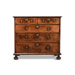 A WILLIAM & MARY FIGURED WALNUT AND FEATHERBANDED CHEST OF DRAWERS, CIRCA 1700